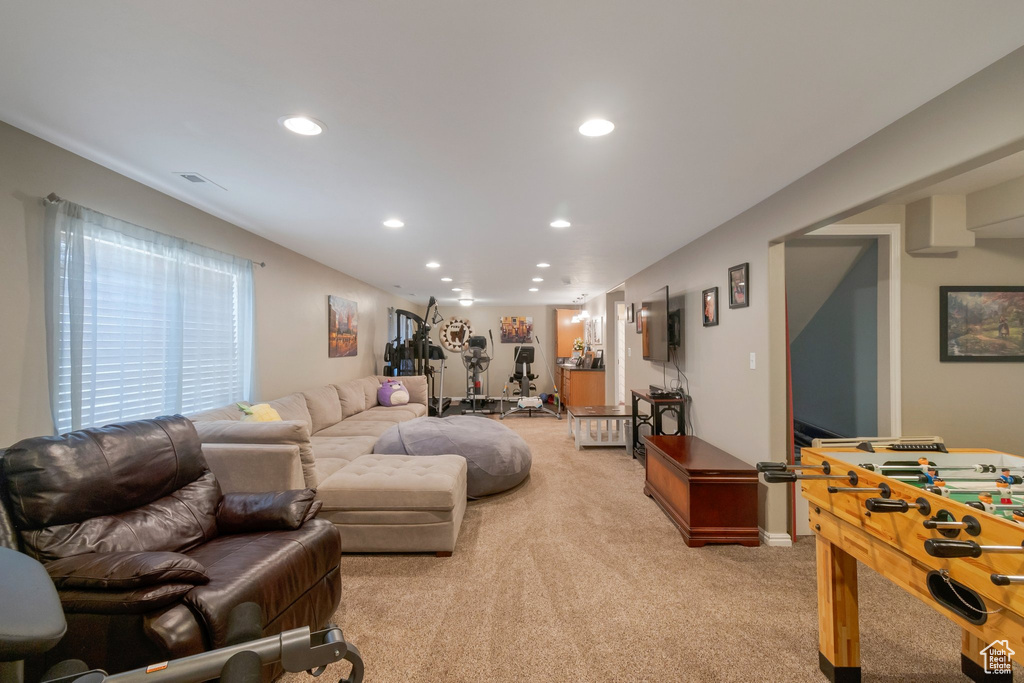 Living area featuring light carpet and recessed lighting