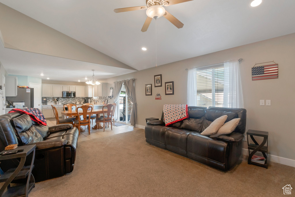 Living area with recessed lighting, plenty of natural light, a ceiling fan, a chandelier, and vaulted ceiling