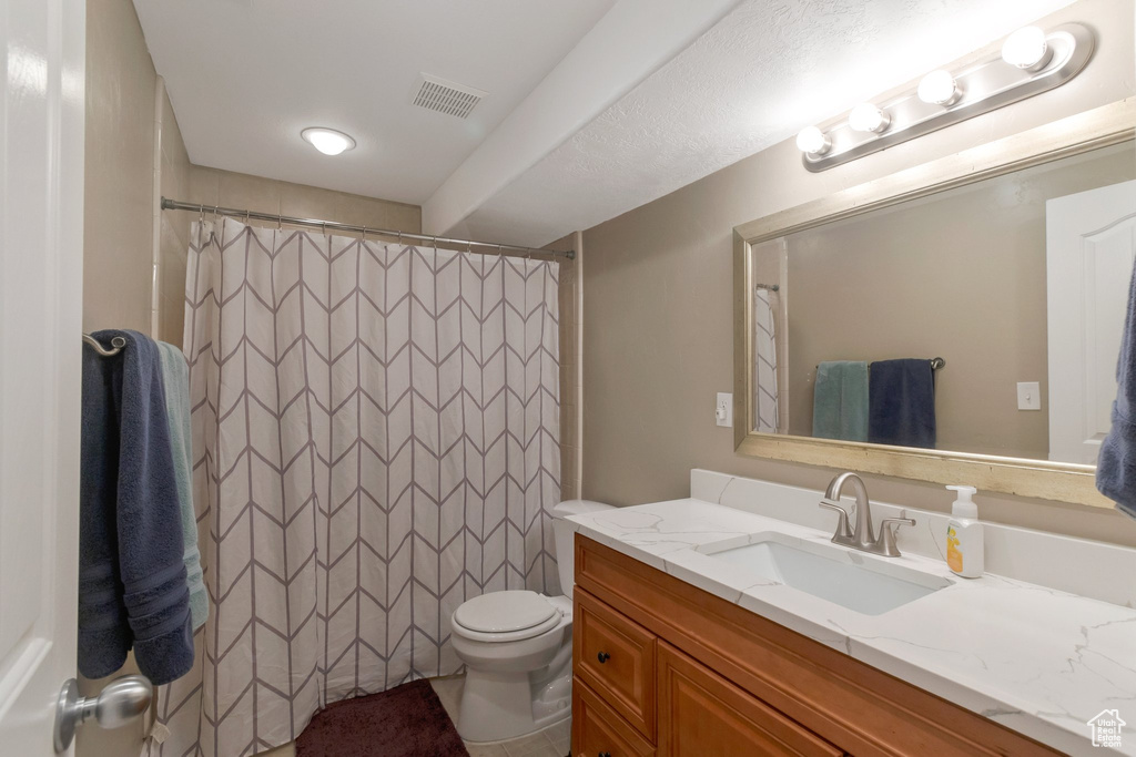 Bathroom with vanity and a shower with shower curtain