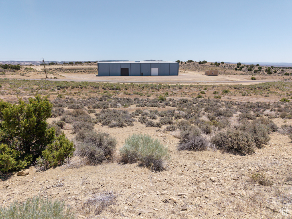 Exterior space with a pole building, a view of countryside, and an outdoor structure