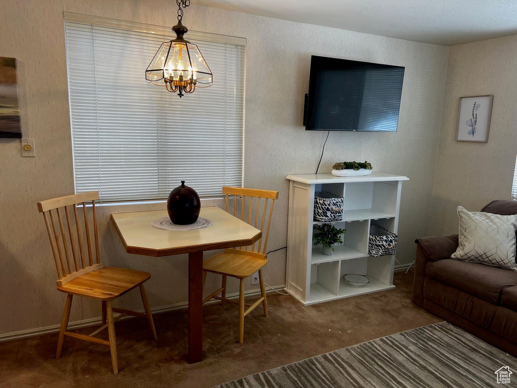 Dining area with a chandelier and carpet