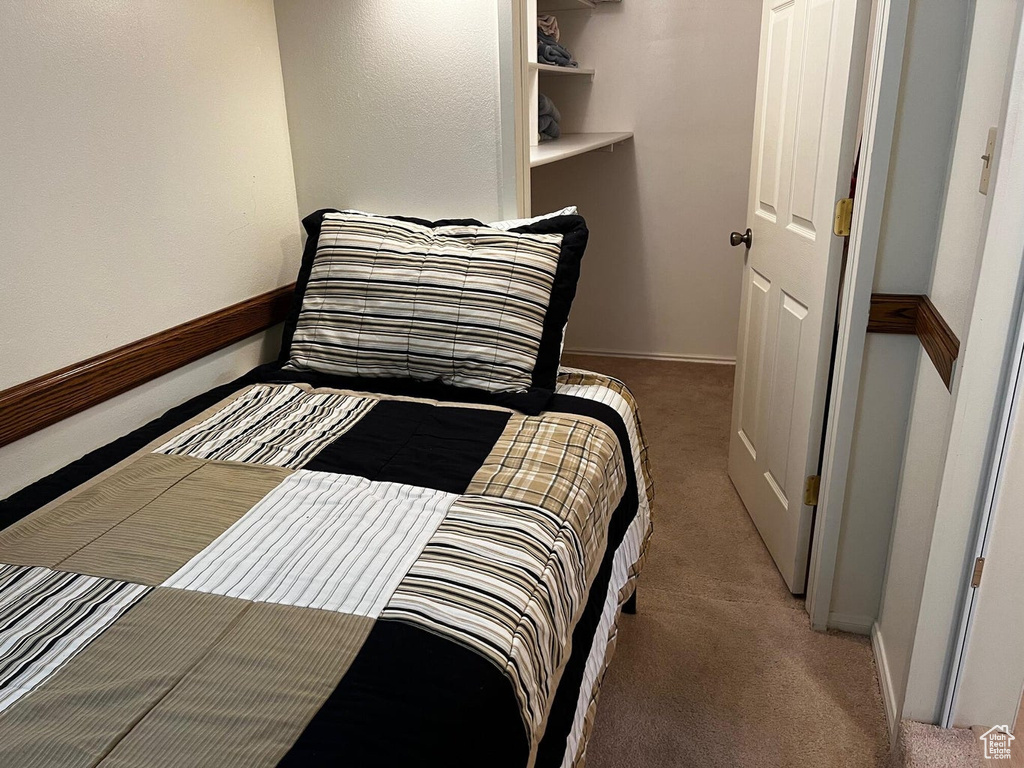 Carpeted bedroom with baseboards