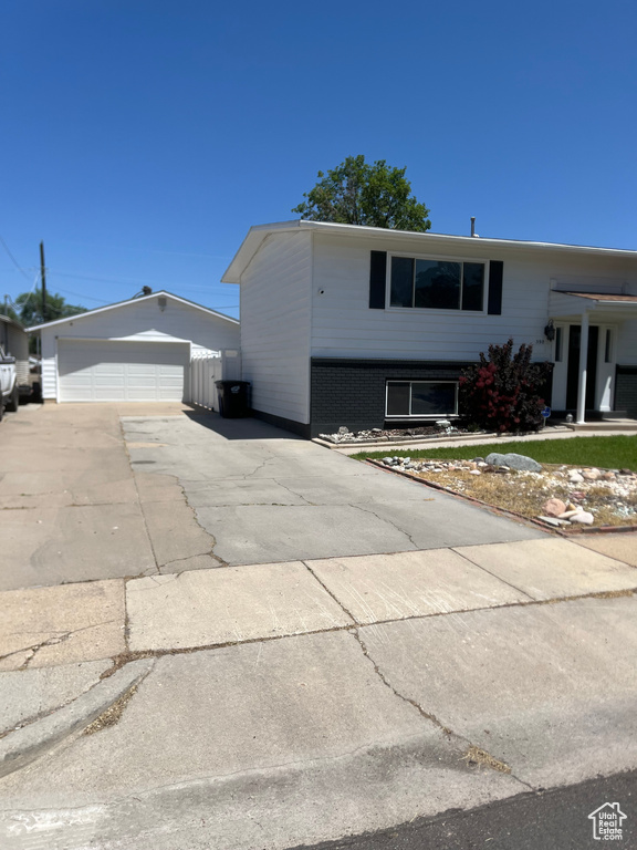 View of front of home featuring a detached garage and an outdoor structure