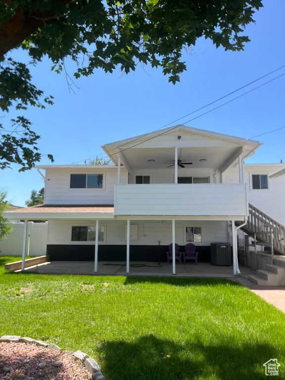 Rear view of house featuring ceiling fan, an outdoor hangout area, a yard, and a patio