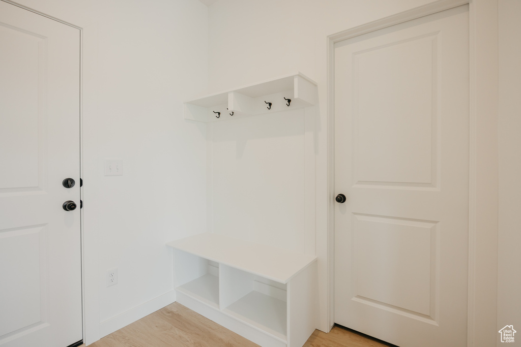 Mudroom with light wood-type flooring and baseboards