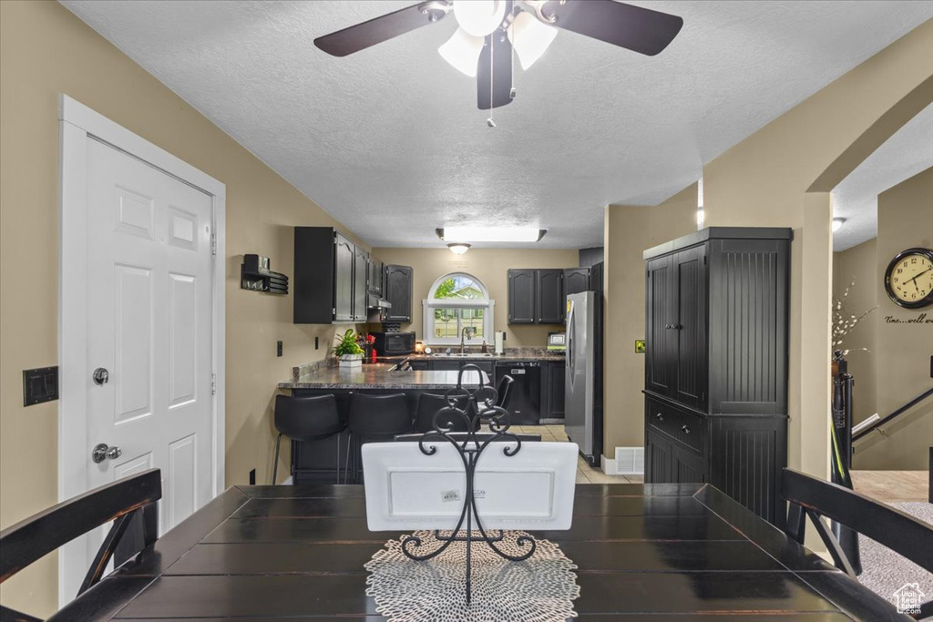 Dining room featuring a textured ceiling and ceiling fan