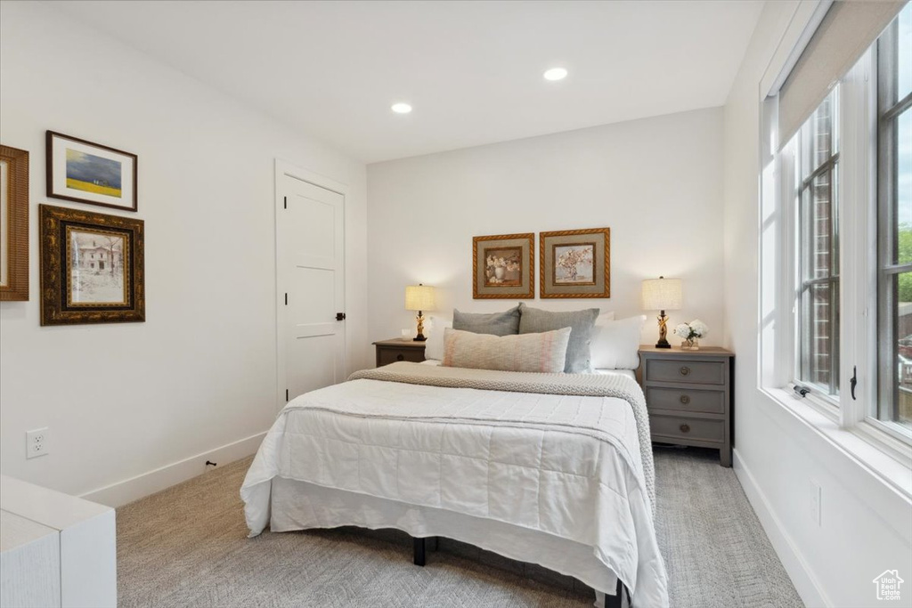 Carpeted bedroom with baseboards and recessed lighting