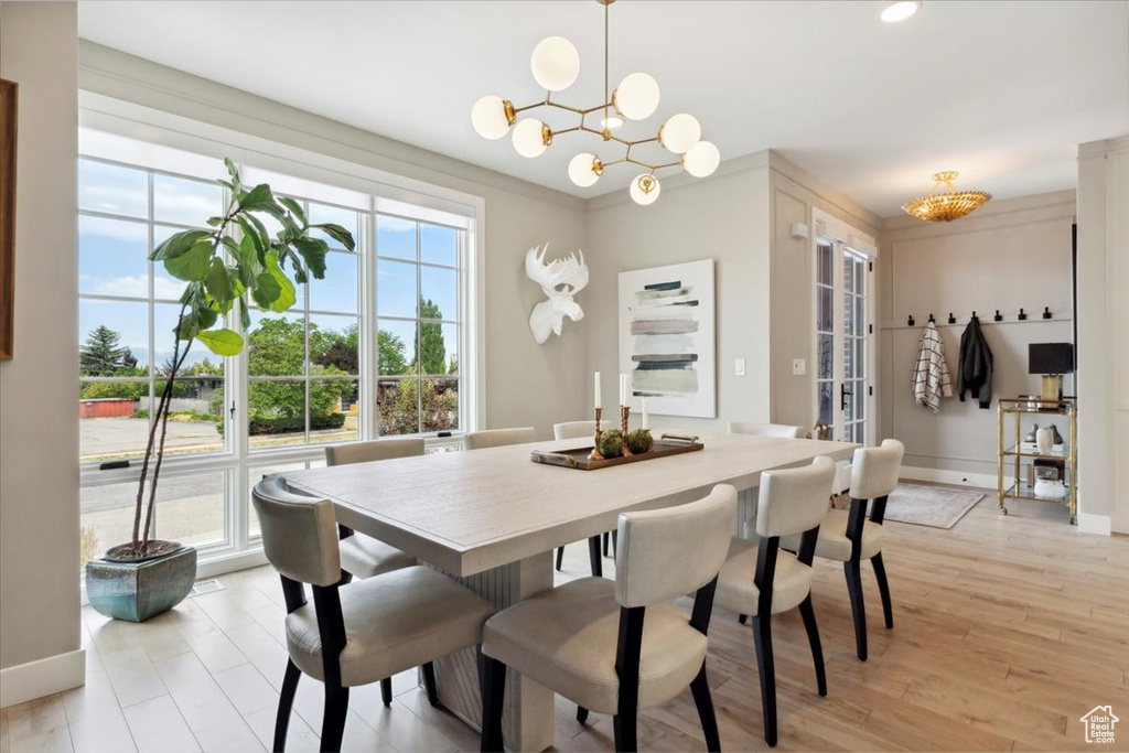 Dining area featuring a chandelier and light wood finished floors