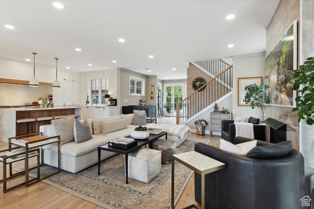 Living area with stairway, light wood-style flooring, and recessed lighting