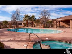Community pool featuring a hot tub and a patio
