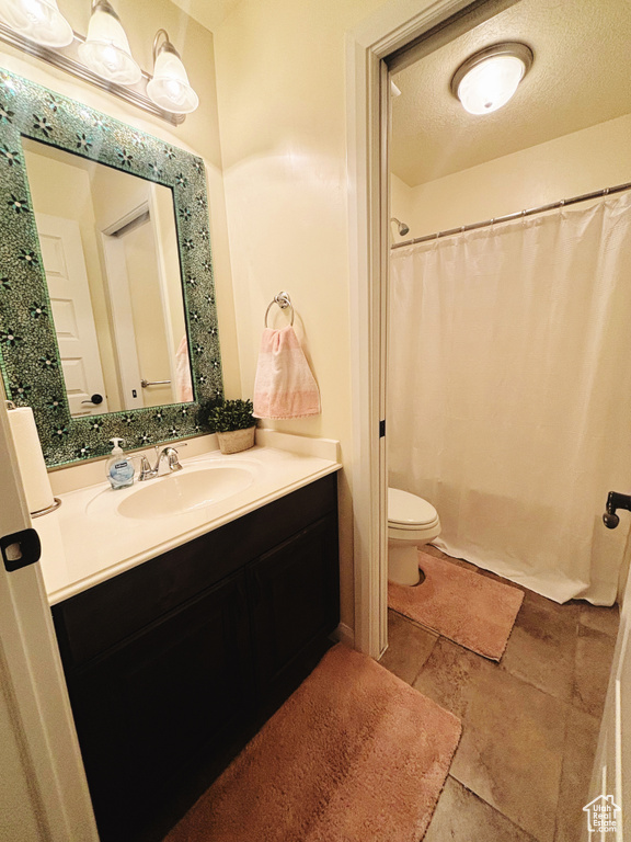 Bathroom featuring vanity and curtained shower