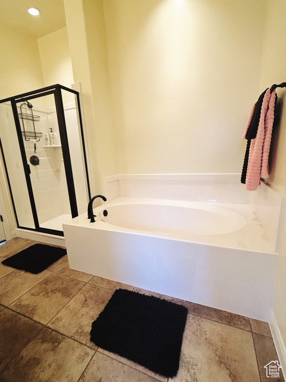 Bathroom featuring a stall shower and a bath