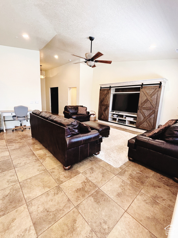 Living room with light tile patterned floors, ceiling fan, a textured ceiling, and recessed lighting