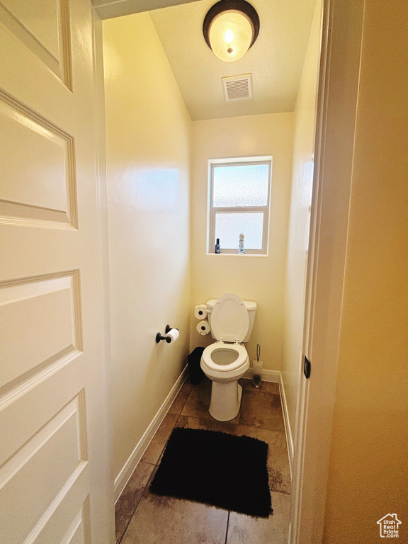 Bathroom with toilet and tile patterned flooring