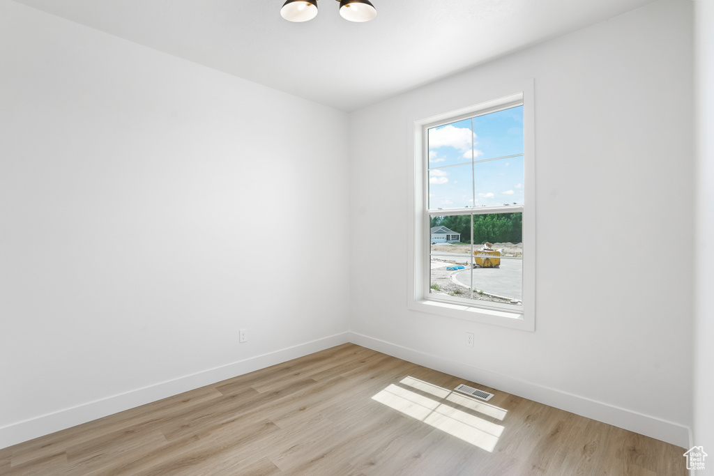 Empty room with light wood-style floors and baseboards