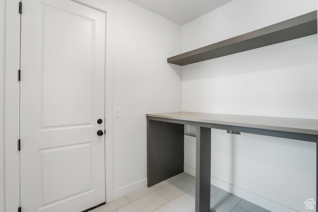 Washroom with baseboards and light tile patterned flooring
