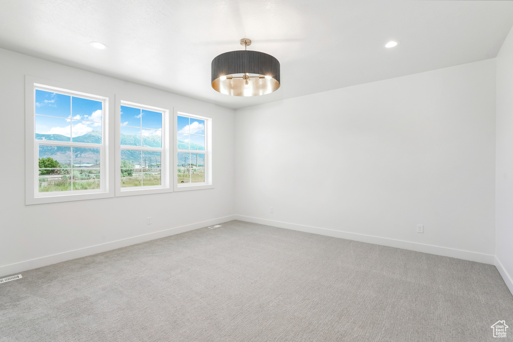 Carpeted empty room featuring baseboards and recessed lighting