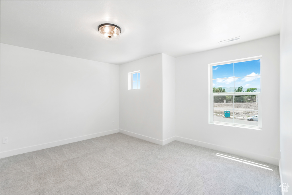 Carpeted empty room with baseboards
