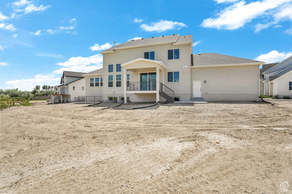 Rear view of house with stucco siding