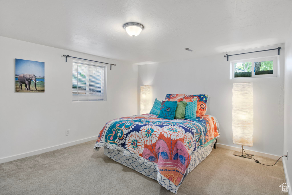 Bedroom featuring carpet floors and baseboards