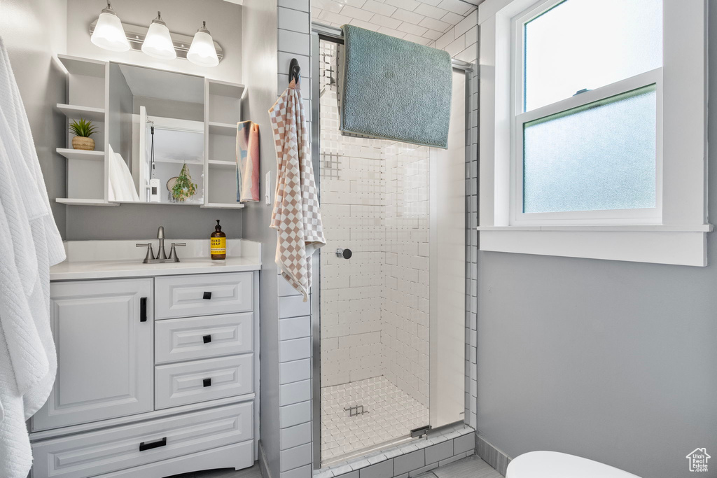 Full bathroom featuring a shower stall and vanity