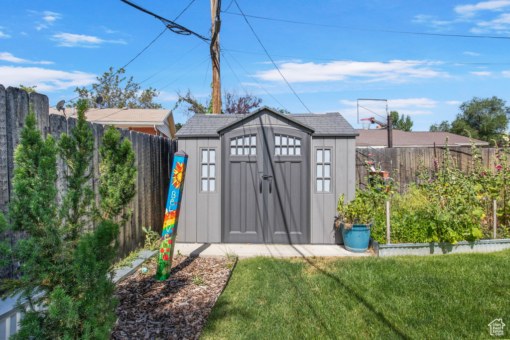 View of shed with a fenced backyard