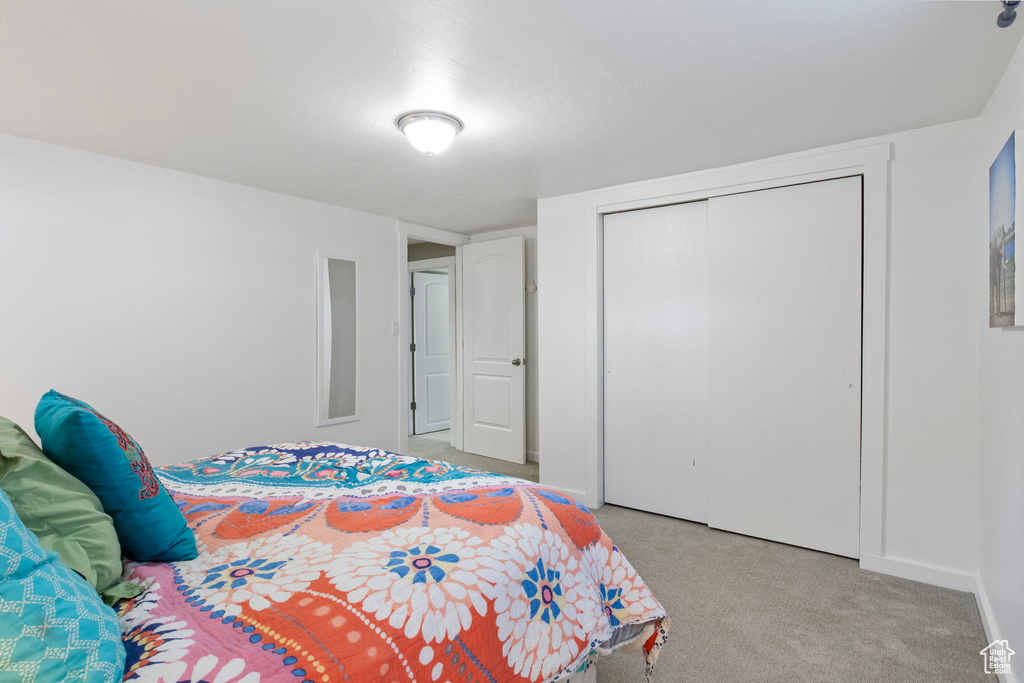 Bedroom with carpet flooring and a closet