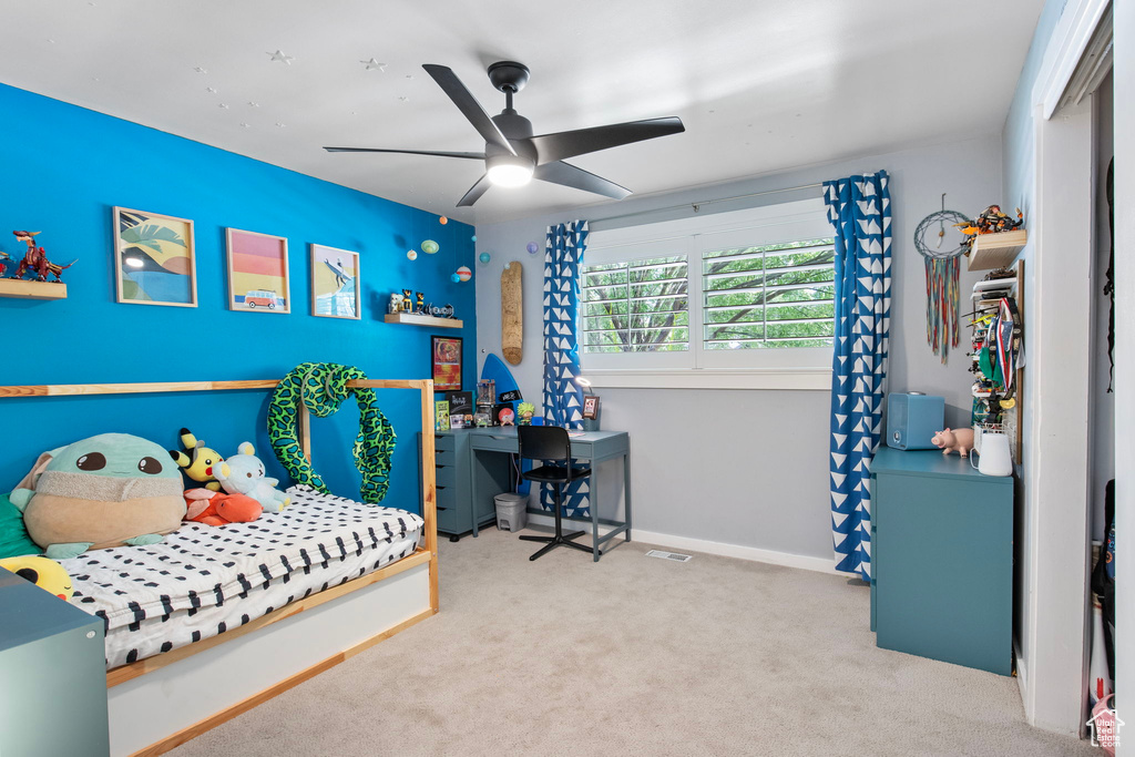 Carpeted bedroom with baseboards and a ceiling fan