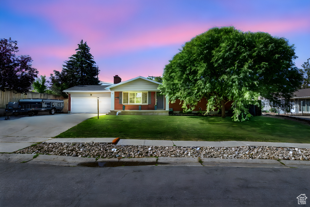 Ranch-style house featuring concrete driveway and a garage