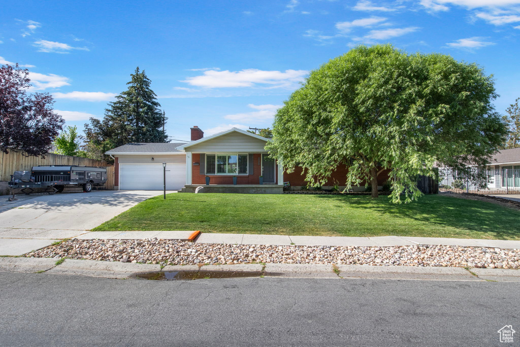 Ranch-style house with a garage and driveway