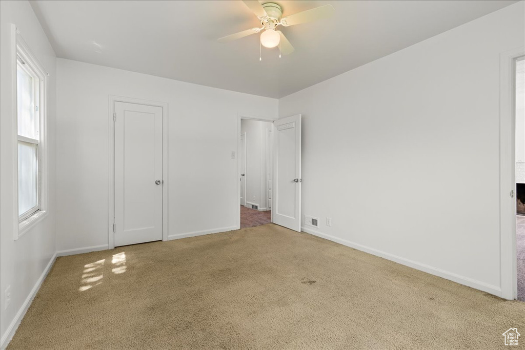 Unfurnished bedroom with carpet flooring and ceiling fan