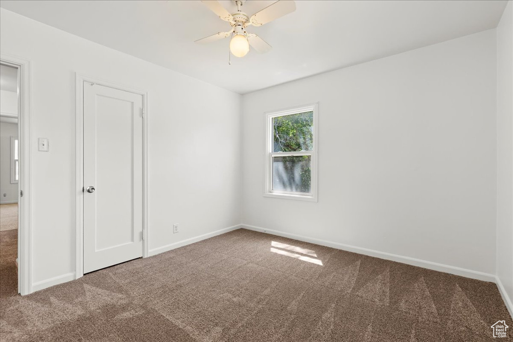 Spare room with carpet floors and a ceiling fan