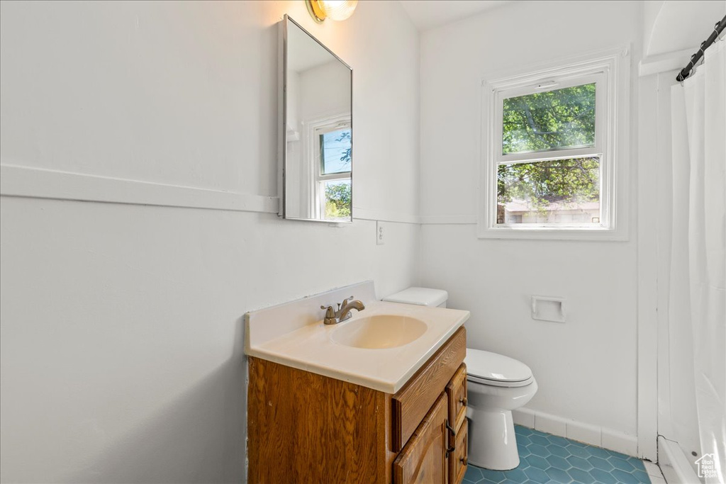 Bathroom with healthy amount of natural light, vanity, and a shower with shower curtain