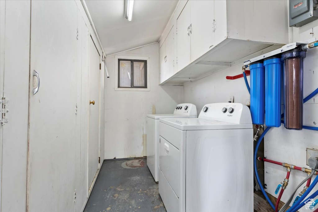 Laundry area featuring washer and clothes dryer and cabinet space