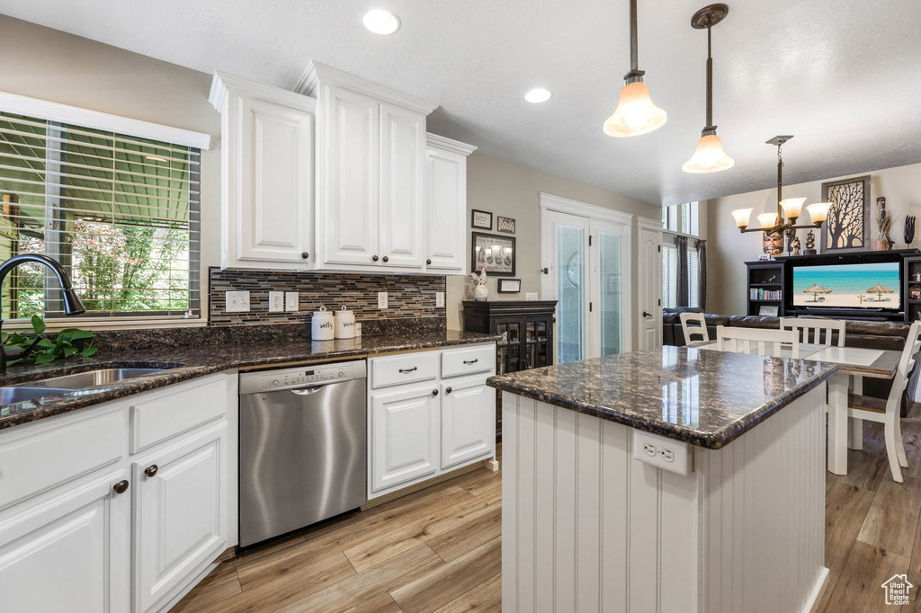 Kitchen featuring stainless steel dishwasher, a chandelier, backsplash, light wood-style floors, and recessed lighting