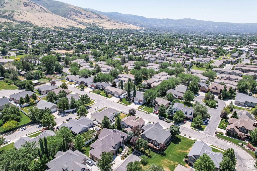 Aerial view of residential area featuring a mountainous background