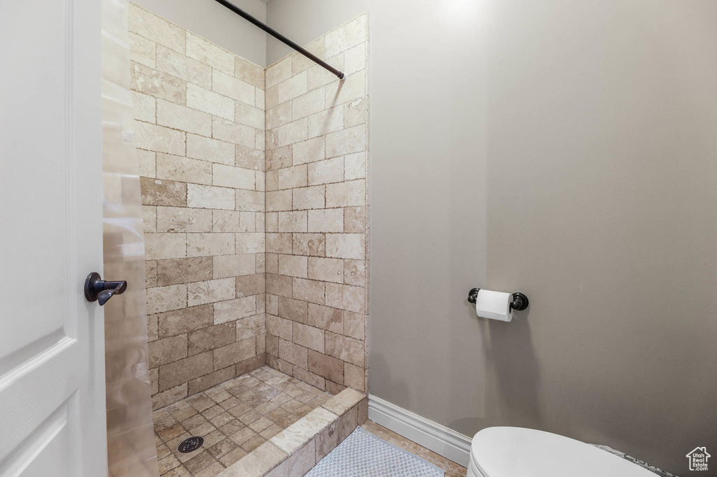Bathroom featuring a stall shower and toilet