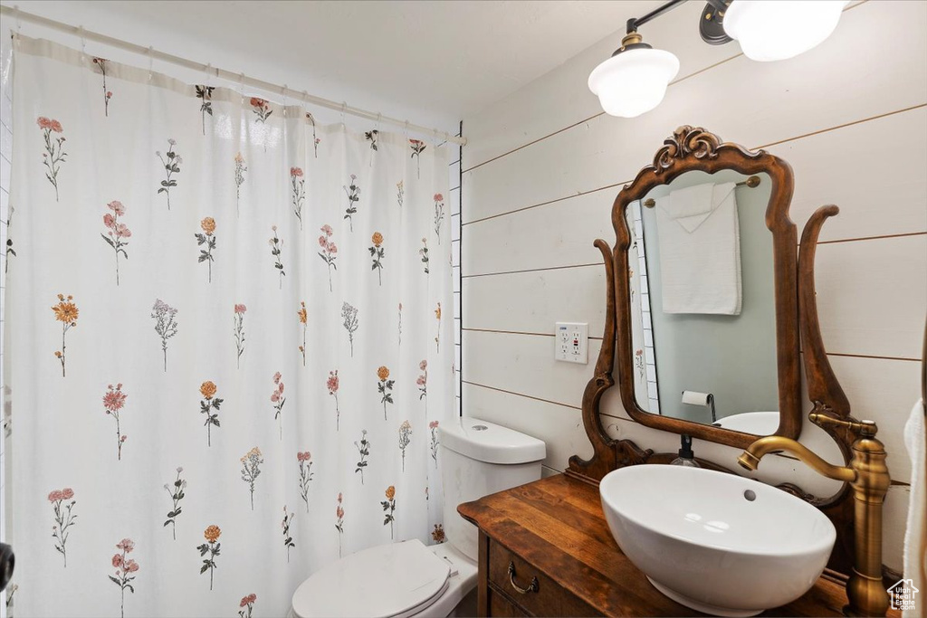 Full bathroom featuring vanity and curtained shower