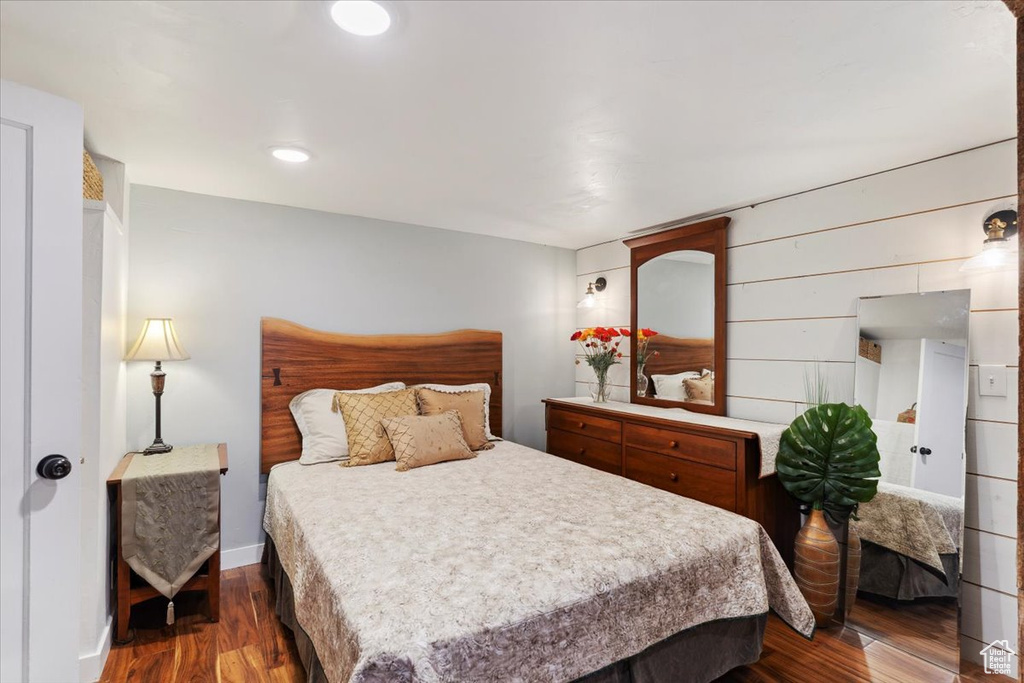 Bedroom with dark wood-style flooring