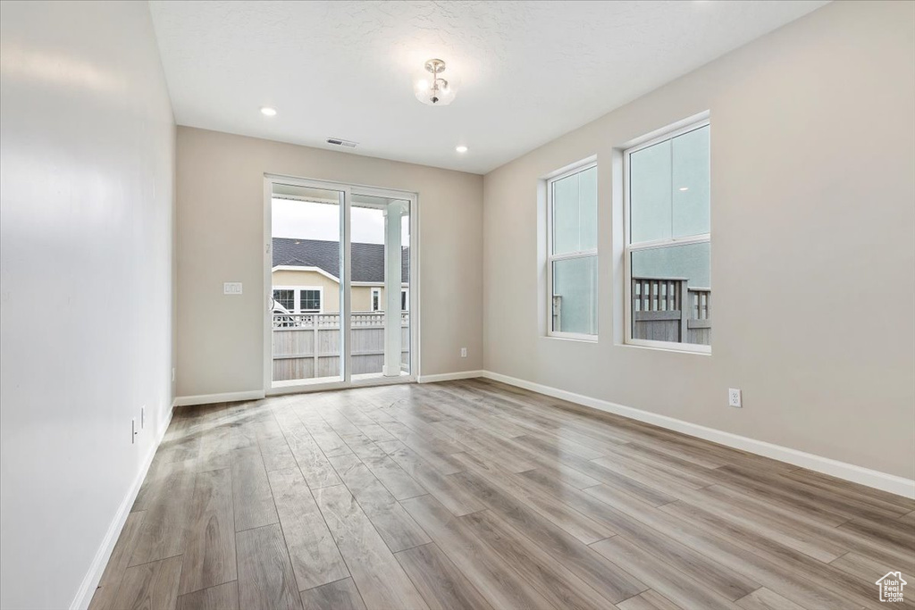 Spare room featuring wood finished floors and recessed lighting