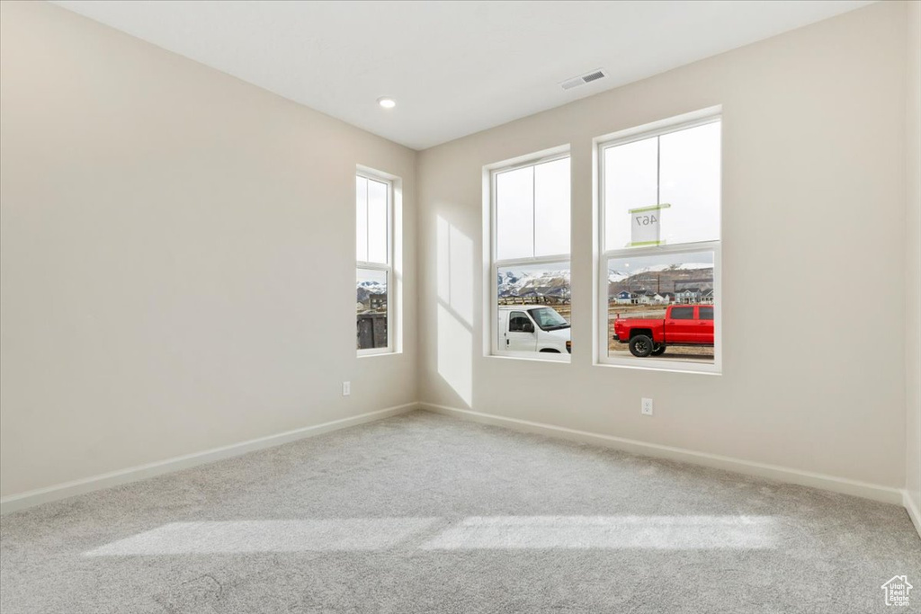 Spare room featuring carpet and recessed lighting
