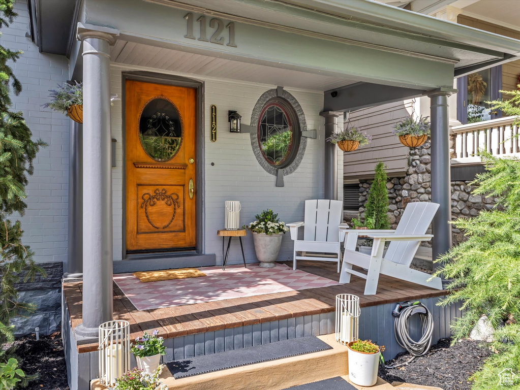 Doorway to property featuring brick siding