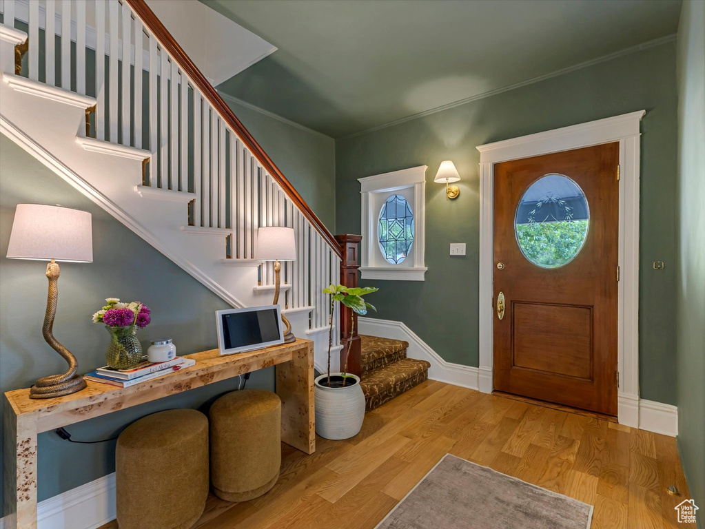 Entryway with stairs and wood finished floors