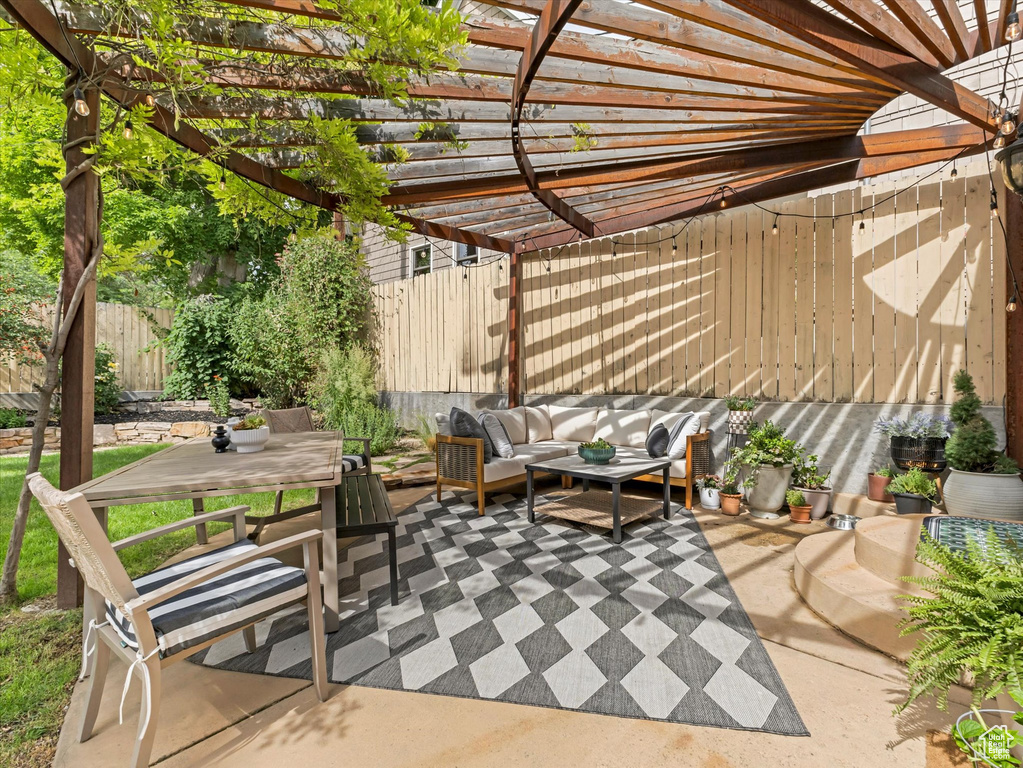 View of patio with an outdoor living space, a pergola, and outdoor dining area