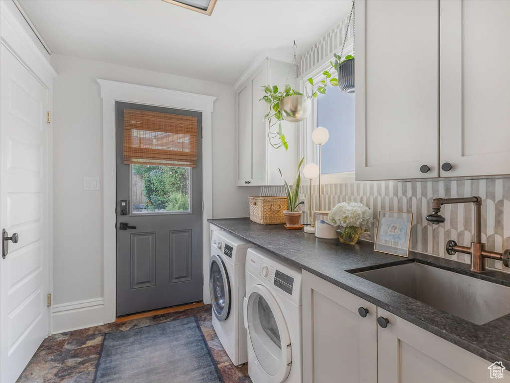 Laundry area with cabinet space and washing machine and clothes dryer