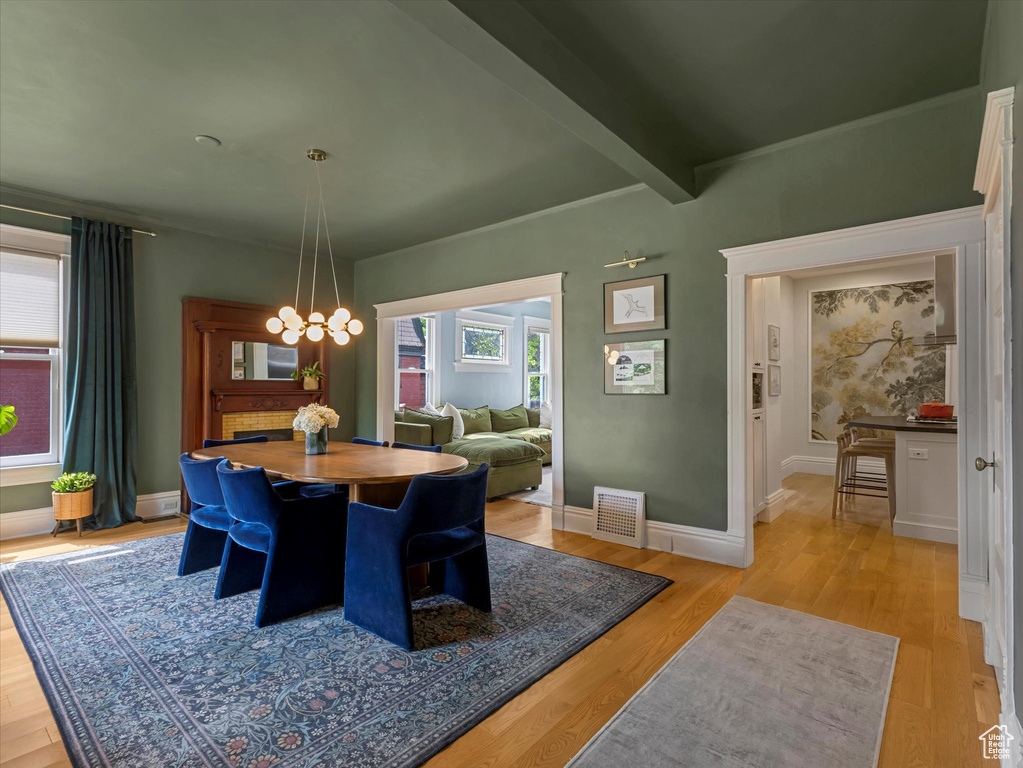 Dining space with a chandelier and light wood-style flooring