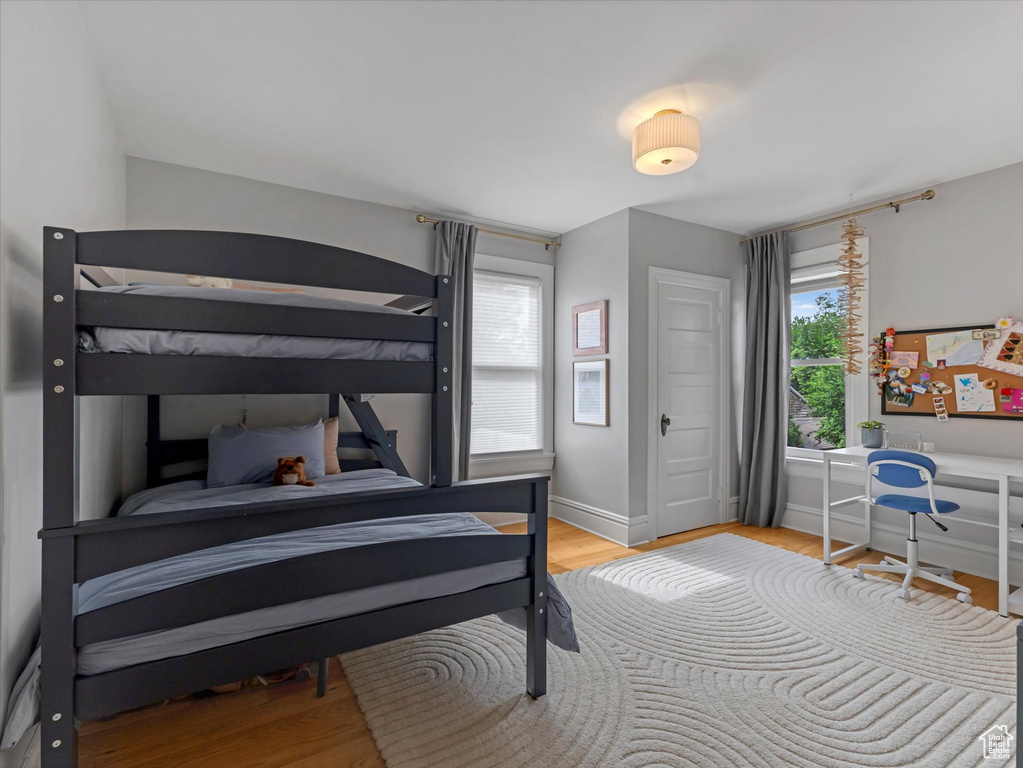 Bedroom with wood finished floors and baseboards