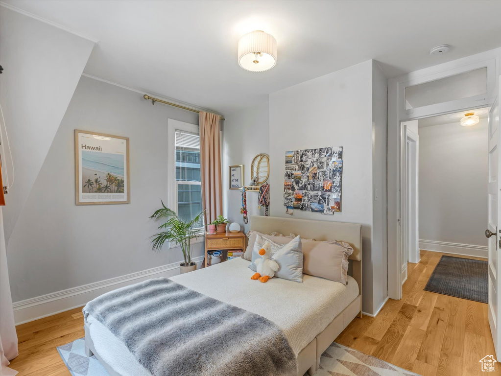 Bedroom featuring light wood-type flooring and baseboards