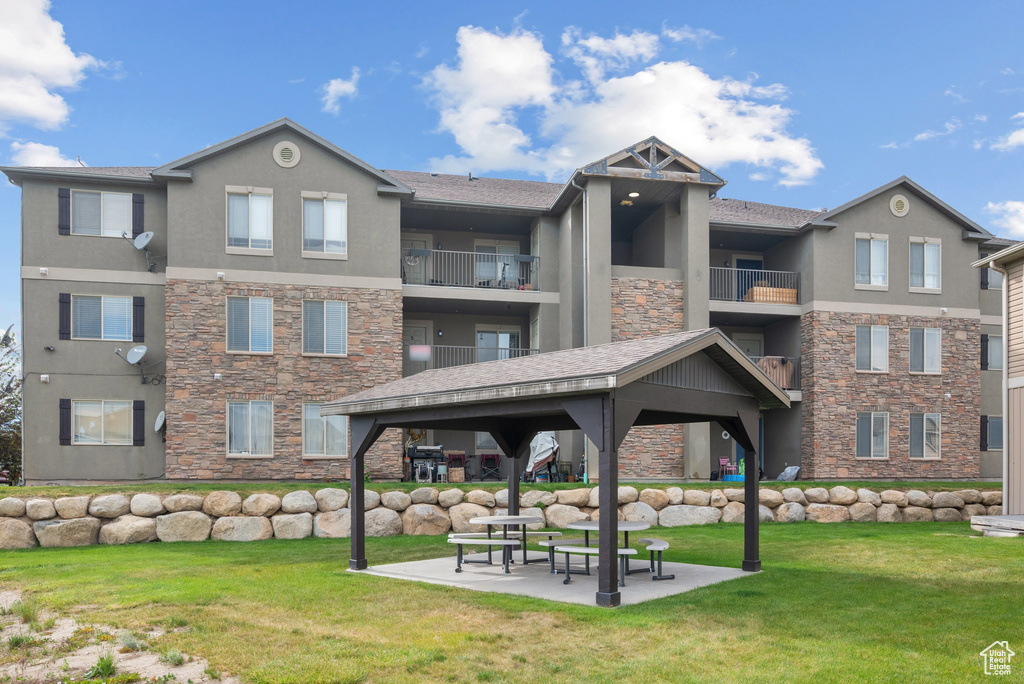 Surrounding community with a gazebo and a yard