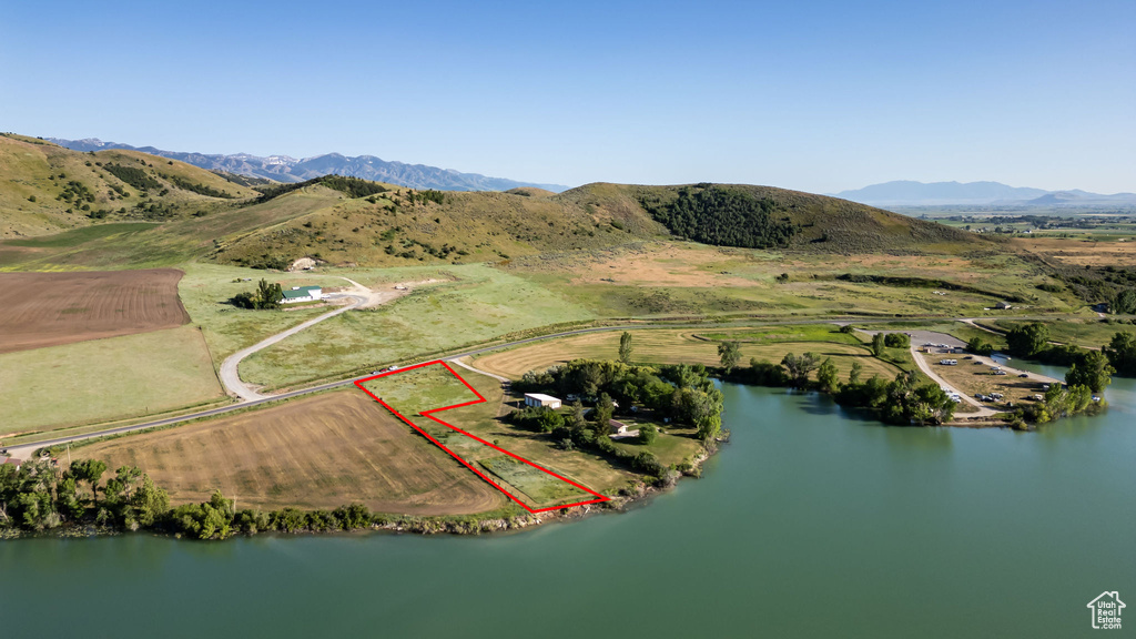 View of rural area with property parcel outlined and a water and mountain view
